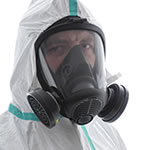 Man in hazmat suit wearing full gas mask